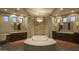 A spacious bathroom with dual sinks, a soaking tub with upscale tiling, and natural light at 30556 N Sage Dr, Peoria, AZ 85383