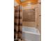 Bathroom featuring shower with decorative tile, a shower curtain, and updated fixtures at 30556 N Sage Dr, Peoria, AZ 85383