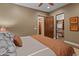 Bedroom featuring a closet, warm colors, and neutral furniture with soft lighting at 30556 N Sage Dr, Peoria, AZ 85383