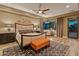 Tastefully decorated bedroom with wood floors, a modern bed frame, a view of the backyard and an elegant rug at 30556 N Sage Dr, Peoria, AZ 85383