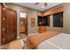 Bedroom showcasing closet space, a comfortable bed, an orange chair, and a large window at 30556 N Sage Dr, Peoria, AZ 85383