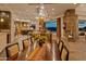 Open-concept dining area features a view to the kitchen and living spaces, stone fireplace, and backyard access at 30556 N Sage Dr, Peoria, AZ 85383