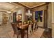 Elegant dining room with a large table, chandelier, and sophisticated window treatments at 30556 N Sage Dr, Peoria, AZ 85383