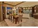 Elegant dining room with seating for six, chandelier lighting, and access to the wine room at 30556 N Sage Dr, Peoria, AZ 85383