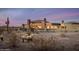 A sprawling home sits serenely amidst desert landscape with mountain backdrop at 30556 N Sage Dr, Peoria, AZ 85383