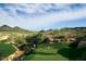 Golf course with desert views, mountains, mature trees, and blue skies with some clouds at 30556 N Sage Dr, Peoria, AZ 85383