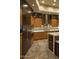 Stylish kitchen showcasing stainless steel appliances, custom cabinetry, a mosaic backsplash, and stone tile floors at 30556 N Sage Dr, Peoria, AZ 85383
