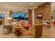 Inviting living room features a stone fireplace, comfortable seating, and seamless indoor-outdoor flow to a pool and desert landscape at 30556 N Sage Dr, Peoria, AZ 85383