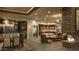 Spacious living area with stone fireplace, comfortable seating, adjacent to the dining room and kitchen at 30556 N Sage Dr, Peoria, AZ 85383