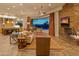 Beautiful living room features a stone fireplace, comfortable seating, and seamless indoor-outdoor flow to a desert pool at 30556 N Sage Dr, Peoria, AZ 85383
