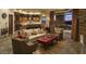 Open-concept living space with seamless indoor-outdoor flow, modern kitchen, and comfortable seating area at 30556 N Sage Dr, Peoria, AZ 85383