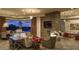 Cozy living room with stone fireplace and a view of the pool at twilight at 30556 N Sage Dr, Peoria, AZ 85383
