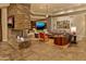Spacious living room featuring stone fireplace, neutral décor, and indoor/outdoor feel at 30556 N Sage Dr, Peoria, AZ 85383