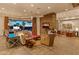 Contemporary living room with a stone fireplace, comfortable seating, and access to a serene outdoor space at 30556 N Sage Dr, Peoria, AZ 85383