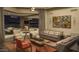 Elegant living room with plush seating, fireplace, and seamless connection to the outdoor space at 30556 N Sage Dr, Peoria, AZ 85383