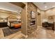 Elegant bedroom with a stone fireplace feature, neutral tones, and integrated access to a home office at 30556 N Sage Dr, Peoria, AZ 85383