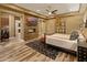 Serene bedroom showcasing a stone fireplace and desk area with modern decor and a ceiling fan at 30556 N Sage Dr, Peoria, AZ 85383