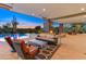 Outdoor patio with comfortable seating, a fireplace, television, and a view of the sparkling pool and desert landscape at 30556 N Sage Dr, Peoria, AZ 85383