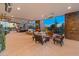 Expansive covered patio with a fireplace, outdoor furniture, and desert views at 30556 N Sage Dr, Peoria, AZ 85383