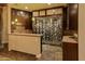 Unique wine cellar featuring custom wood cabinetry, glass enclosure, and adjacent countertop at 30556 N Sage Dr, Peoria, AZ 85383