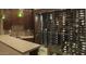 Custom wine room with glass enclosure and storage racks filled with bottles, along with a wet bar at 30556 N Sage Dr, Peoria, AZ 85383