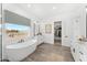 Bright bathroom featuring a freestanding tub, dual vanities, and a separate walk-in closet at 33401 N 142Nd Way, Scottsdale, AZ 85262