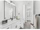 Modern bathroom featuring double vanity, a black framed mirror, and stylish fixtures at 33401 N 142Nd Way, Scottsdale, AZ 85262