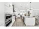 Modern white kitchen with stainless steel appliances, large island, and ample cabinet space at 33401 N 142Nd Way, Scottsdale, AZ 85262