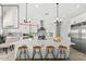 Bright, modern kitchen with stainless steel appliances, oversized island, and pendant lighting at 33401 N 142Nd Way, Scottsdale, AZ 85262