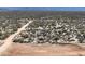 Desert landscape with a dirt road, low vegetation, and distant mountains. New land to build on at 33401 N 142Nd Way, Scottsdale, AZ 85262