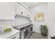 Well-organized laundry room with modern appliances, ample cabinet space, and stylish decor at 33401 N 142Nd Way, Scottsdale, AZ 85262