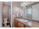 Bathroom featuring granite countertop, framed mirror, towel rack and cabinet storage at 3432 E Jasper Dr, Gilbert, AZ 85296