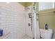 Bathroom showcasing a walk-in shower with white subway tiles, niche, and shower curtain at 3432 E Jasper Dr, Gilbert, AZ 85296