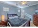 Bedroom featuring a ceiling fan, window, and an en-suite bathroom at 3432 E Jasper Dr, Gilbert, AZ 85296