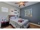 Bedroom featuring a ceiling fan and a window allowing natural light at 3432 E Jasper Dr, Gilbert, AZ 85296