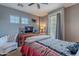 Bedroom featuring a ceiling fan, two windows, and a door leading to a private balcony at 3432 E Jasper Dr, Gilbert, AZ 85296