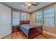 Inviting bedroom with hardwood floors, a comfortable bed, and natural light from the large windows at 3432 E Jasper Dr, Gilbert, AZ 85296