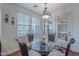 Cozy breakfast nook with a glass table, ornate chairs, and natural light streaming through the windows at 3432 E Jasper Dr, Gilbert, AZ 85296