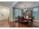 Dining room featuring hardwood floors, white trim, and a vintage wood china cabinet at 3432 E Jasper Dr, Gilbert, AZ 85296