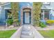 Inviting entryway with decorative stone archway and lush green landscaping and grass at 3432 E Jasper Dr, Gilbert, AZ 85296