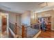 Spacious hallway leading to a home office, featuring hardwood floors and decorative iron railings at 3432 E Jasper Dr, Gilbert, AZ 85296
