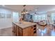 Open concept kitchen and living room featuring granite island and stainless steel appliances at 3432 E Jasper Dr, Gilbert, AZ 85296