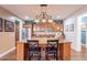 Open-concept kitchen featuring an island with granite countertops and dark wood cabinets at 3432 E Jasper Dr, Gilbert, AZ 85296