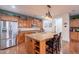 Spacious kitchen with granite island, stainless steel appliances, and wooden cabinetry at 3432 E Jasper Dr, Gilbert, AZ 85296