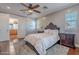 Main bedroom showcasing an ensuite bathroom with a large bed, classic furnishings and an ensuite bathroom at 3432 E Jasper Dr, Gilbert, AZ 85296