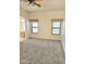 Bedroom with two windows, neutral walls, carpet, and adjacent bath at 37509 N 7Th N St, Phoenix, AZ 85086