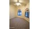 Neutral bedroom with carpet, ceiling fan, and two arched windows with view at 37509 N 7Th N St, Phoenix, AZ 85086