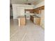 Kitchen with an island, wooden cabinets and white appliances, tiled floors at 37509 N 7Th N St, Phoenix, AZ 85086