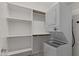 Functional laundry area featuring a stackable washer/dryer and built-in shelving at 38 S 197Th Ln, Buckeye, AZ 85326