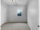 Neutral bedroom featuring plush carpet, bright light from a window and a closet with sliding doors at 41285 W Sussex Dr, Maricopa, AZ 85138